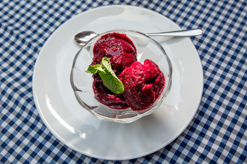 dessert of strawberry puree with mint on a served table