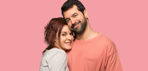 Couple in valentine day hugging over isolated pink background