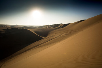 Fototapeta na wymiar Sunset over deserts of Peru close to Huacachina