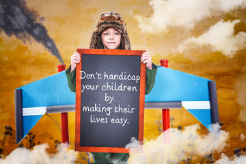 Boy carrying chalkboard with quote