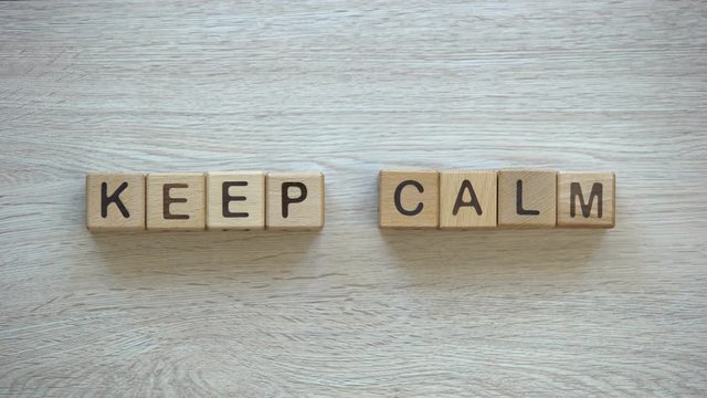 Keep calm, stop motion words on wooden cubes, positive thinking and motivation
