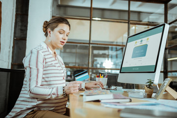 Pregnant woman sitting in front of computer and working hard