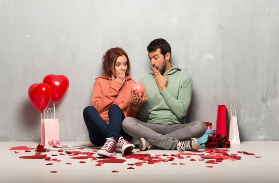 Couple in valentine day surprised while holding a piggybank - Powered by Adobe