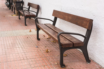 Wooden bench in the city park outdoors
