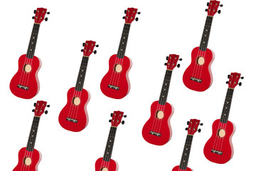 red ukulele on white background. small guitar isolate