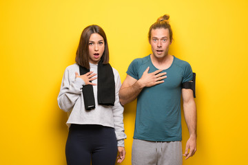 Group of athletes over yellow background surprised and shocked while looking right