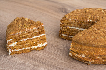 Cut cake on a wooden background