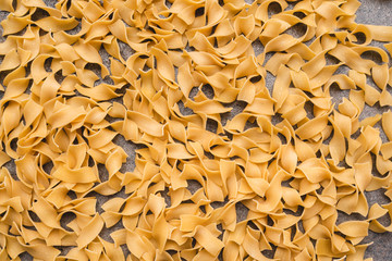 Different types of pasta that we use every day in the kitchen when cooking. View from above. Products flat-lying. Place for a description or text. A product made of flour and eggs.