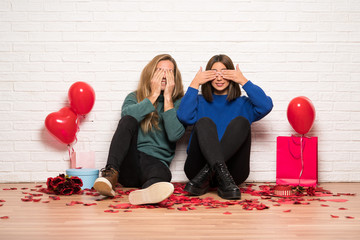 Couple in valentine day covering eyes by hands