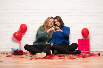 Couple in valentine day making a heart with hands