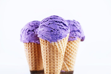 Blueberry ice cream with cone isolated on white background