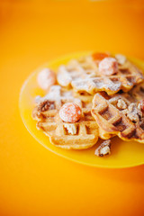 Traditional belgian waffles with fresh fruit and nuts. Orange.