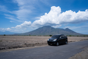 Fototapeta na wymiar car in dry savanna landscape with the beautiful sky