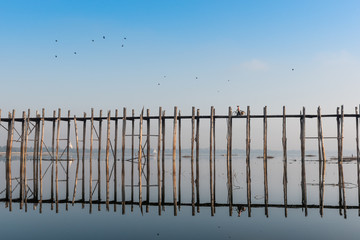 Lifestyle people with bicycle at U bein bridge on the morning after sunrise, Mandalay Myanmar