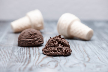 chocolate ice cream with waffle cone on wooden background