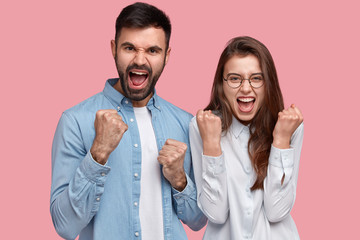 We can do it. Successful team of coworkers clench fists, celebrate victory, exclaim positively,...