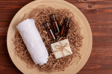 Essential oils in small brown glass bottles on wooden background