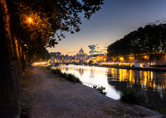 Fototapeta na wymiar Saint peters basilica under beautiful sky and light reflecting in tiber river. italy Rome.