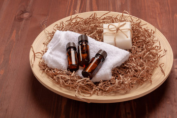  Essential oils in small brown glass bottles on wooden background
