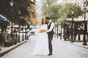 Naklejka premium Handsome loving couple newlyweds gently embrace, romantic wedding moment