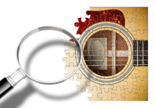Patience and passion to learn to play the guitar step by step - concept image in puzzle shape seen through a magnifying glass