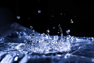 Water drops splashing on acoustic membrane. A lot of drops in air. High frequency of sound waves....