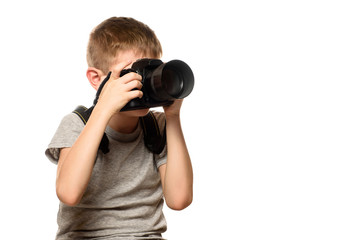 Boy takes pictures on the camera. Portrait. Isolate on white background