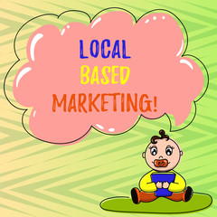 Fototapeta premium Conceptual hand writing showing Local Based Marketing. Business photo showcasing marketing way that depends on the location of client Baby Sitting on Rug Pacifier Book and Cloud Speech Bubble