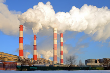 Thermal power plant, smoke from the chimney against blue sky