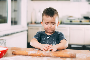 The child makes dough dumplings or dumplings is fun with enthusiasm