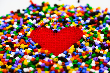 Red heart of red constructor on a constructor background