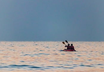 Couple o kayak sailing on the beach/ sea during sunset on beautiful location Palolem beach Goa India 
