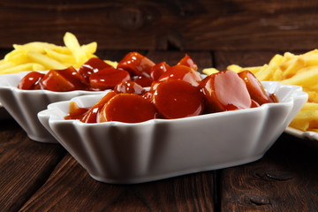 currywurst with fries. traditional german food with sausages and curry