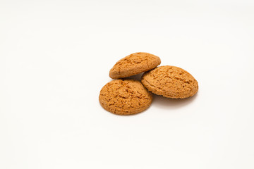 Three homemade oatmeal cookies isolated on white background. Closeup
