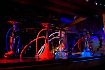 Group of eastern hookahs on table of a bar.