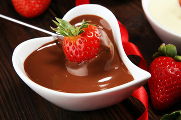 Valentine Chocolate fondue melted with fresh strawberries and dark and white chocolate. Tublips and sugar hearts.