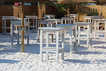 tables and chair of a beach bar without people