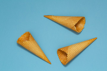 Ice cream cones pattern. Blue background. Sweet, summer concept. Flat lay. Top view. Closeup