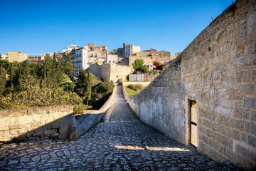 Naklejka premium Gravina in Puglia, with the Roman two-level bridge that extends over the canyon. Apulia, Italy.
