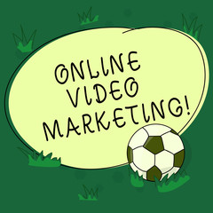 Text sign showing Online Video Marketing. Conceptual photo Engaging video into the marketing campaigns Soccer Ball on the Grass and Blank Outlined Round Color Shape photo