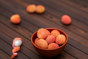 Lychees fruits on wooden background. Litchi on wood background with copy space