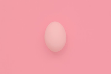 White Easter egg on pastel background. Happy Easter concept. Minimal concept. Flat lay. Top view.
