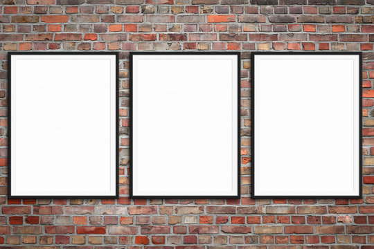 three blank picture frames on brick wall -  framed poster mock-up with stone wall background -