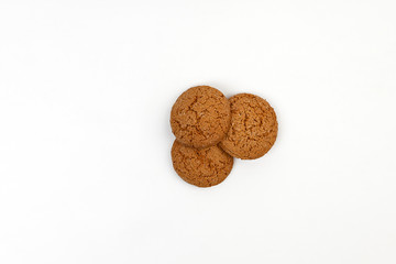 Three homemade oatmeal cookies isolated on white background. Closeup 