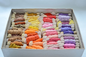 Skeins of colorful threads in a warm colors for embroidery and sewing in the box