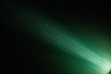 A narrow beam of white light on a green background to the point