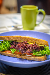 Beef Bacon and Cheddar on Rye sandwich with cafe latte