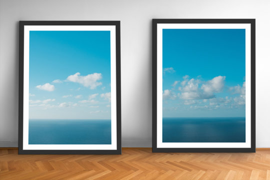 framed picture prints of ocean and blue sky landscape photography on wooden floor  -