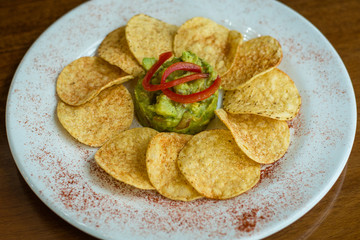 Freshly made spicy guacamole and corn chips