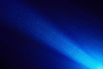 Narrow white ray of light on a blue background in a black dot
